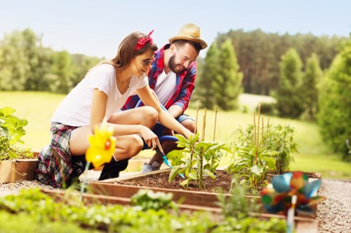 Gardener discussing a complaint on site near a residential garden