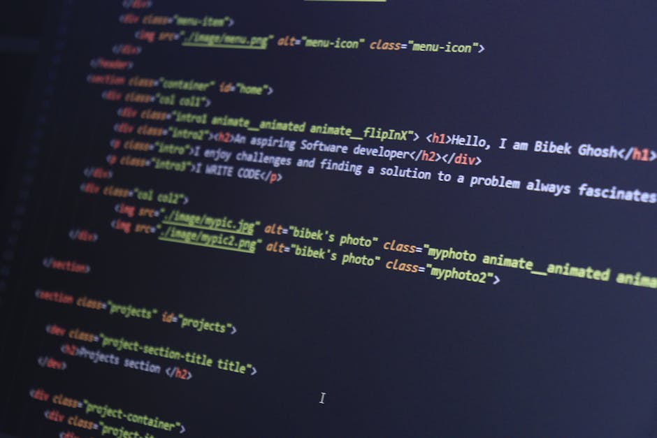 A close-up photograph of a computer screen displaying lines of HTML code in various colors, including yellow, blue, green, and red. Parts of the code include tags such as <h1>, <div>, and <img>, with 